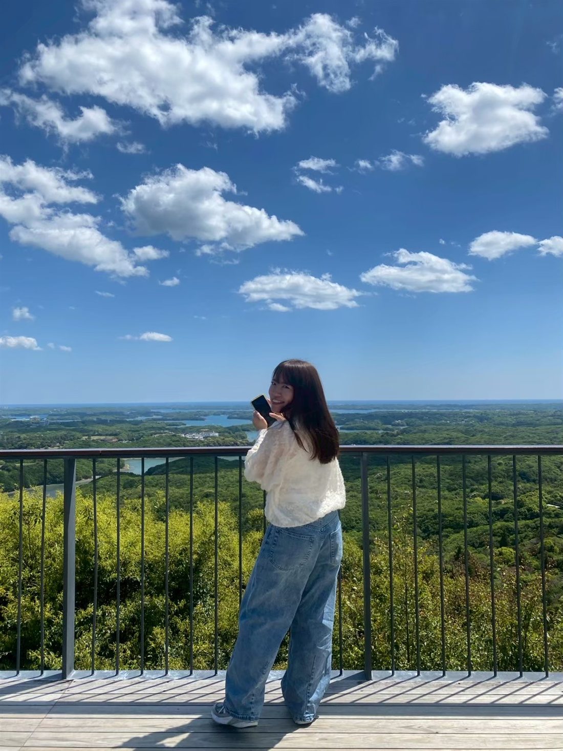 Miyu at a lookout, turning back with a smile